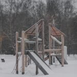 a playground in the snow with a slide